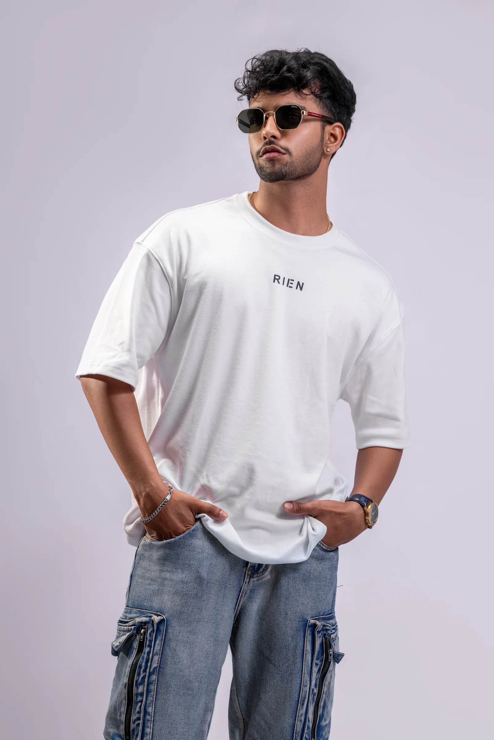 Model wearing a white Rien oversized tee